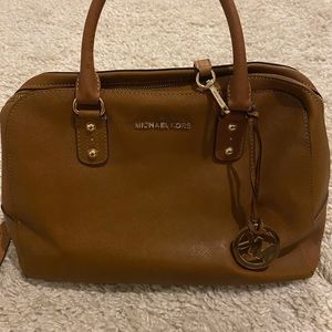 Brown leather Michael Kors purse, lettering in gold.